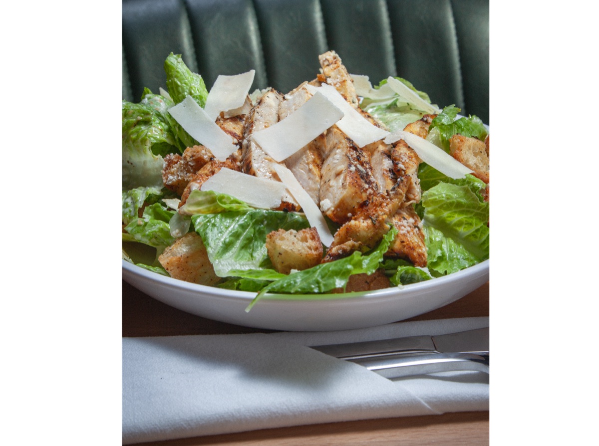Caesar salad with grilled chicken, parmesan, croutons and pulled pork bacon crumbles