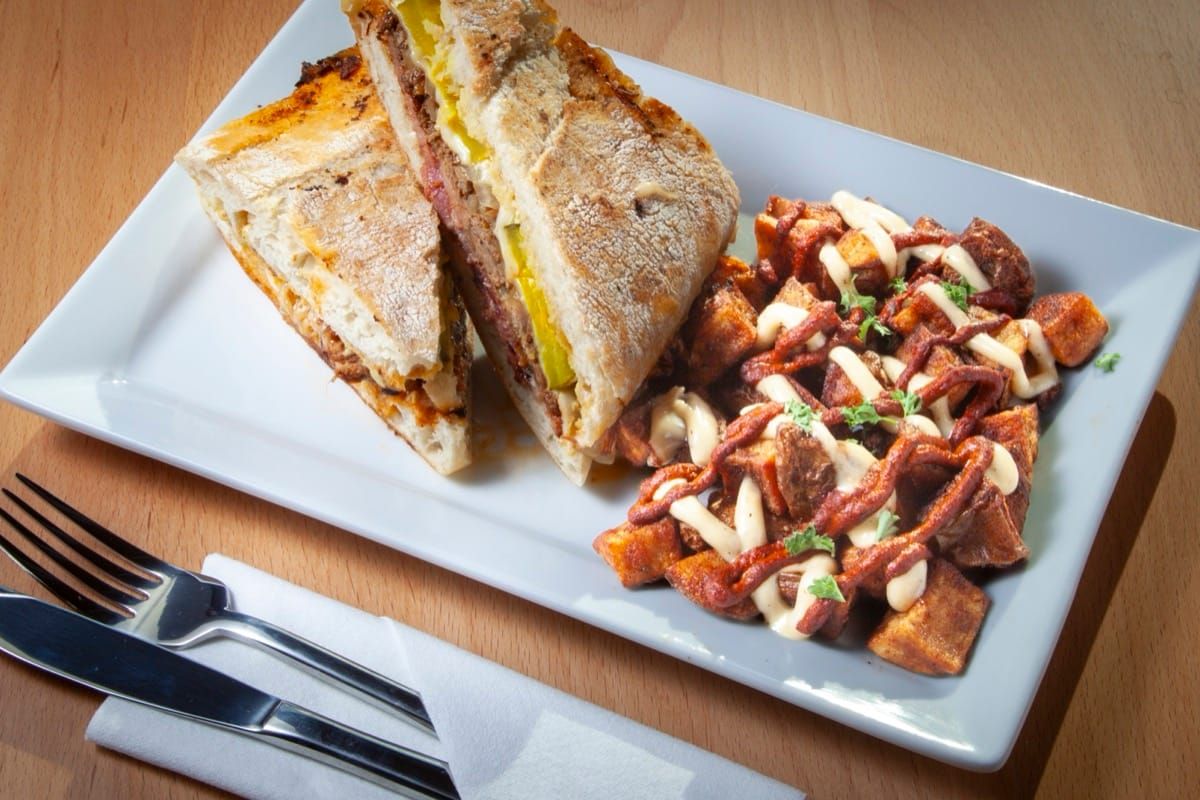Pressed Cuban sandwich with roasted pork, ham, pickles and cheese